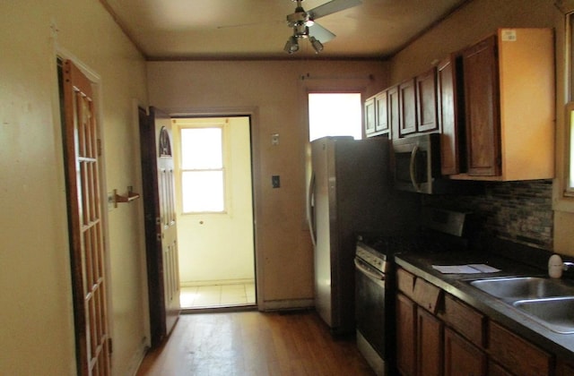7319 S Claremont Ave, Chicago, IL 60636 - kitchen featuring electric range, light wood-style flooring, a ceiling fan, stainless steel microwave, and dark countertops