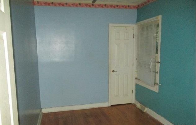 7319 S Claremont Ave, Chicago, IL 60636 - empty room featuring wood finished floors and baseboards