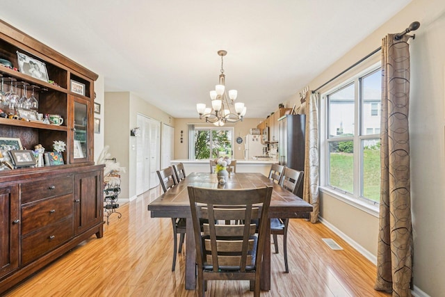 1192 Sumac Trl, Hoffman Estates, IL 60192 - dining room with a chandelier and light wood finished floors