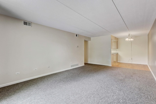 512 Redondo Dr Unit 112, Downers Grove, IL 60516 - empty room featuring light colored carpet and a chandelier