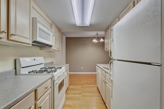 512 Redondo Dr Unit 112, Downers Grove, IL 60516 - kitchen with white appliances, light wood-type flooring, light countertops, a chandelier, and cream cabinets