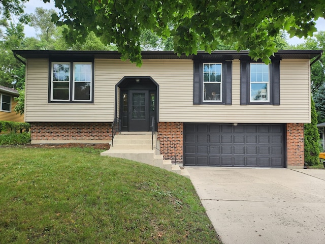 814 S 11th Ave, Saint Charles, IL 60174 - split foyer home featuring a front lawn, driveway, brick siding, and a garage