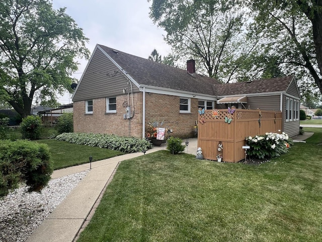 201 S Roy Ave, Northlake, IL 60164 - back of property featuring brick siding, a chimney, a lawn, and a shingled roof