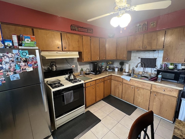 201 S Roy Ave, Northlake, IL 60164 - kitchen with freestanding refrigerator, white range with gas stovetop, under cabinet range hood, black microwave, and a ceiling fan