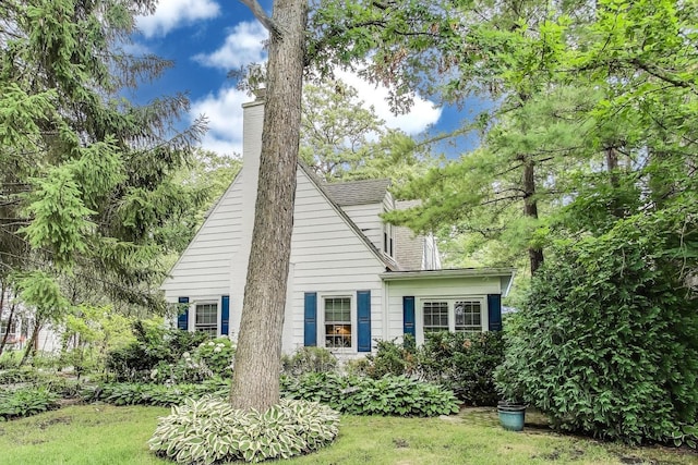 1667 Sunnyside Ave, Highland Park, IL 60035 - view of front of house featuring a chimney and a front lawn
