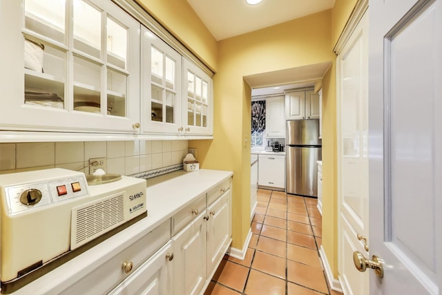 1667 Sunnyside Ave, Highland Park, IL 60035 - bar featuring freestanding refrigerator, decorative backsplash, light tile patterned flooring, dishwasher, and recessed lighting