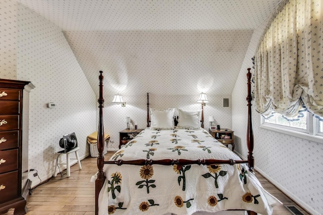 1667 Sunnyside Ave, Highland Park, IL 60035 - bedroom with wallpapered walls, light wood-type flooring, and lofted ceiling