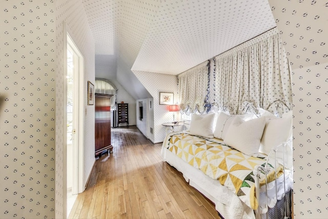 1667 Sunnyside Ave, Highland Park, IL 60035 - bedroom with wallpapered walls, hardwood / wood-style flooring, lofted ceiling, and multiple windows