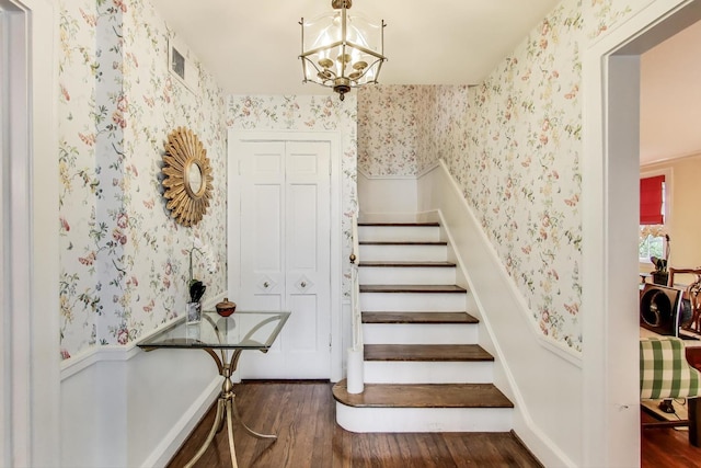 1667 Sunnyside Ave, Highland Park, IL 60035 - staircase featuring wallpapered walls, wood finished floors, and a chandelier