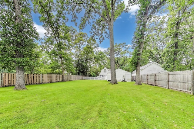 1667 Sunnyside Ave, Highland Park, IL 60035 - fenced backyard with view of wooded area and an outdoor structure