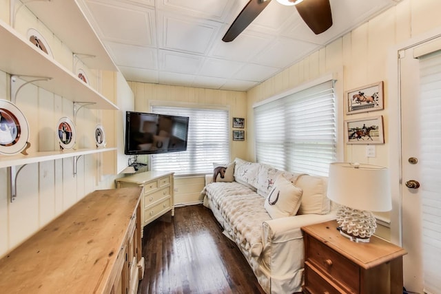 1667 Sunnyside Ave, Highland Park, IL 60035 - living room featuring dark wood finished floors, ceiling fan, an ornate ceiling, and wooden walls