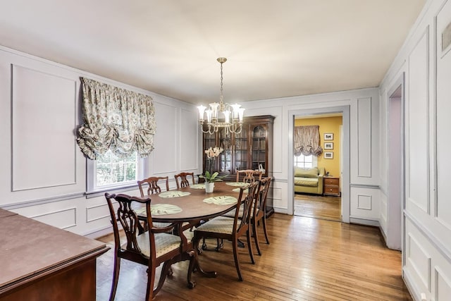 1667 Sunnyside Ave, Highland Park, IL 60035 - dining space with a decorative wall, a chandelier, and light wood-style floors