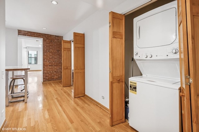 40 E 9th St Unit 903, Chicago, IL 60605 - laundry area with estacked washer and dryer, light wood-style floors, brick wall, and recessed lighting
