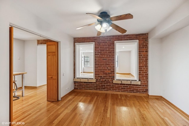 40 E 9th St Unit 903, Chicago, IL 60605 - empty room featuring a ceiling fan, light wood-type flooring, and brick wall