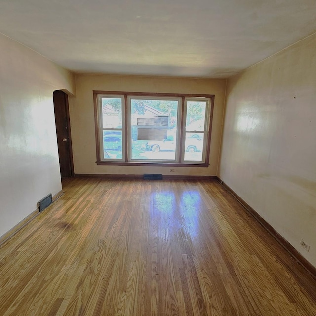 4804 S Lamon Ave, Chicago, IL 60638 - unfurnished room featuring wood finished floors, plenty of natural light, and arched walkways