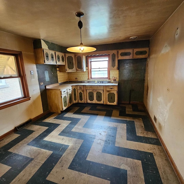 4804 S Lamon Ave, Chicago, IL 60638 - kitchen with light countertops, tasteful backsplash, brown cabinets, and decorative light fixtures