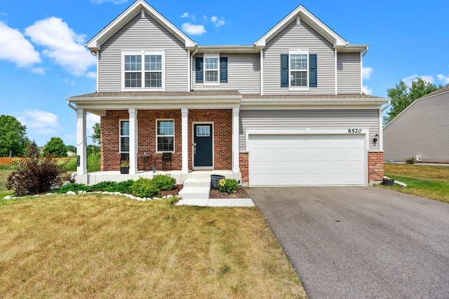 8520 White Oaks Ct, Wonder Lake, IL 60097 - traditional home featuring an attached garage, asphalt driveway, a front lawn, brick siding, and covered porch