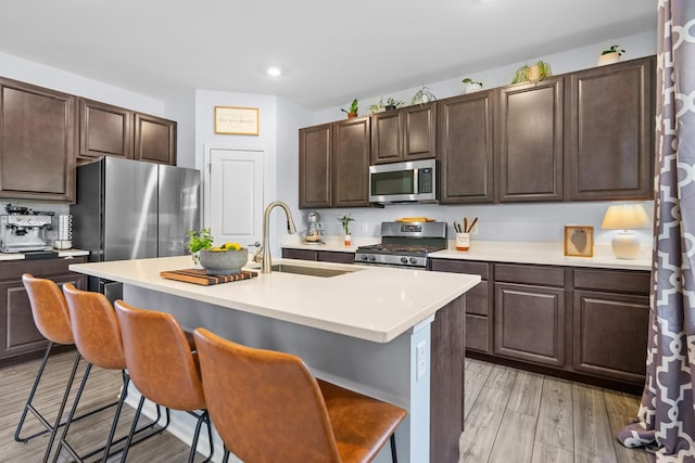 8520 White Oaks Ct, Wonder Lake, IL 60097 - kitchen featuring stainless steel appliances, a kitchen bar, light countertops, recessed lighting, and dark brown cabinets