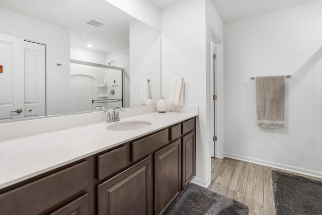 8520 White Oaks Ct, Wonder Lake, IL 60097 - full bath with vanity, wood finished floors, a shower with shower door, and recessed lighting