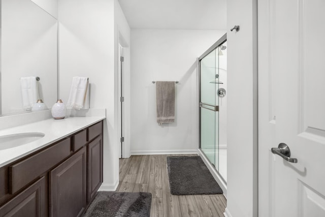 8520 White Oaks Ct, Wonder Lake, IL 60097 - bathroom with a shower stall, vanity, and wood finished floors