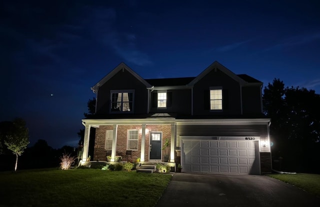 8520 White Oaks Ct, Wonder Lake, IL 60097 - traditional-style home featuring driveway, a garage, a lawn, brick siding, and a porch