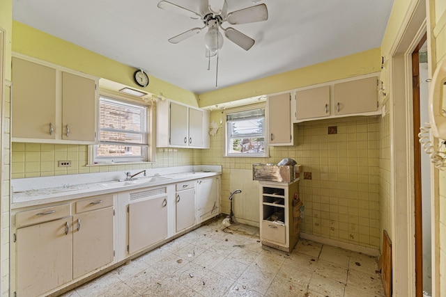 3713 S 57th Ct, Cicero, IL 60804 - kitchen with light countertops, a ceiling fan, and tile walls