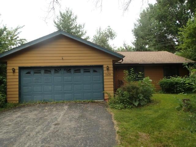 3430 Treadway Ct, Rockford, IL 61103 - ranch-style house with an attached garage and asphalt driveway
