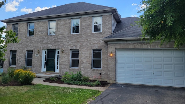 630 Maple Ct, Elburn, IL 60119 - traditional-style home with asphalt driveway, brick siding, a garage, and a shingled roof