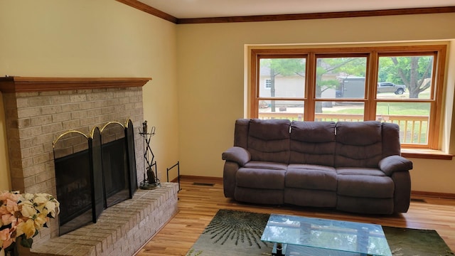 630 Maple Ct, Elburn, IL 60119 - living area featuring a brick fireplace, light wood-style flooring, and crown molding