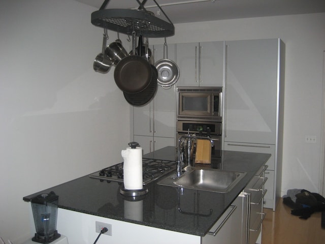 653 N Kingsbury St Unit 1208, Chicago, IL 60654 - kitchen with stainless steel microwave, black oven, and gas cooktop