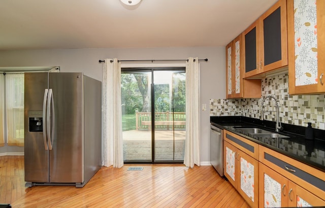 29W324 Grove Ave, West Chicago, IL 60185 - kitchen with stainless steel appliances, light wood-style floors, tasteful backsplash, brown cabinets, and glass insert cabinets
