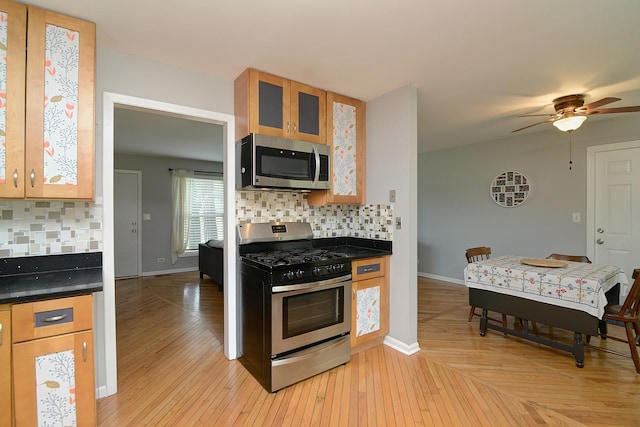29W324 Grove Ave, West Chicago, IL 60185 - kitchen with appliances with stainless steel finishes, decorative backsplash, ceiling fan, and dark countertops