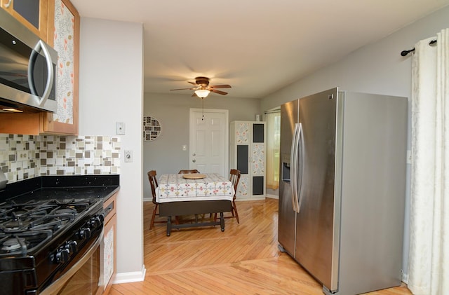 29W324 Grove Ave, West Chicago, IL 60185 - kitchen featuring appliances with stainless steel finishes, ceiling fan, light wood-type flooring, and tasteful backsplash