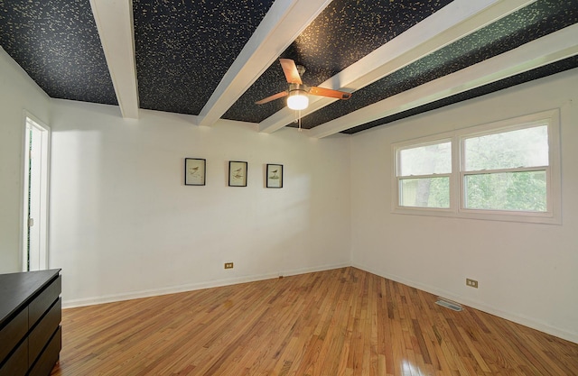29W324 Grove Ave, West Chicago, IL 60185 - unfurnished room featuring beam ceiling, light wood-style flooring, and a ceiling fan