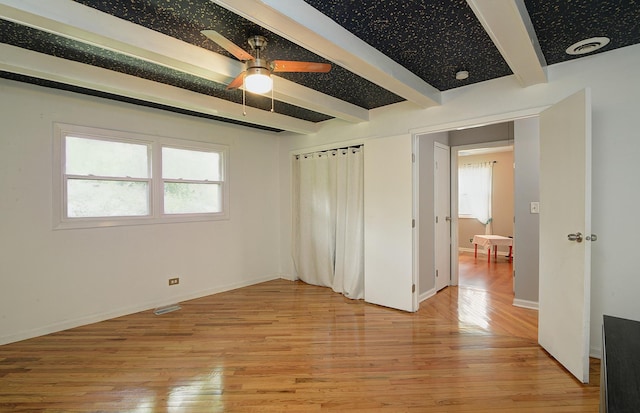 29W324 Grove Ave, West Chicago, IL 60185 - unfurnished bedroom featuring beamed ceiling and light wood-style flooring