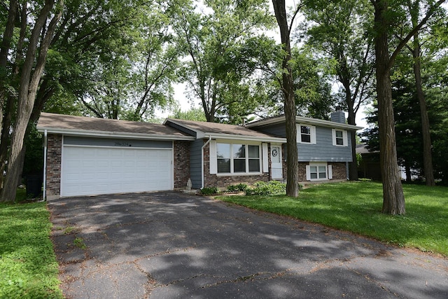 29W324 Grove Ave, West Chicago, IL 60185 - split level home with driveway, brick siding, a garage, a chimney, and a front yard