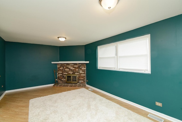 29W324 Grove Ave, West Chicago, IL 60185 - unfurnished living room with a fireplace and wood finished floors