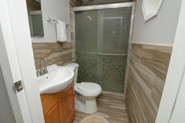 29W324 Grove Ave, West Chicago, IL 60185 - full bath featuring tile walls, a shower stall, vanity, and a wainscoted wall