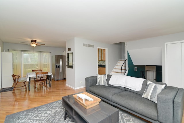 29W324 Grove Ave, West Chicago, IL 60185 - living room featuring light wood-type flooring, a ceiling fan, and stairway
