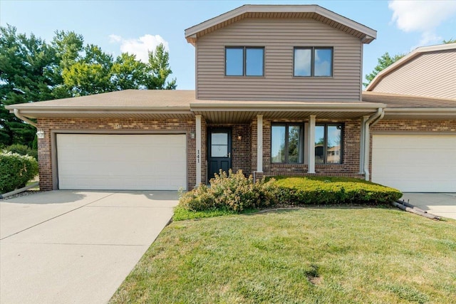 141 Manor Cir, Bloomington, IL 61704 - traditional-style house with a garage, concrete driveway, brick siding, and a front yard