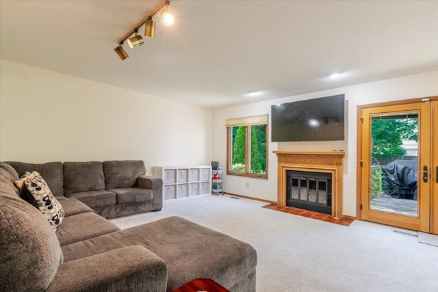 141 Manor Cir, Bloomington, IL 61704 - living room with carpet floors, a fireplace with flush hearth, and track lighting