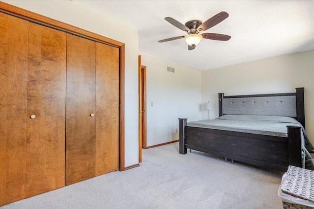 141 Manor Cir, Bloomington, IL 61704 - bedroom featuring light carpet, a closet, and ceiling fan