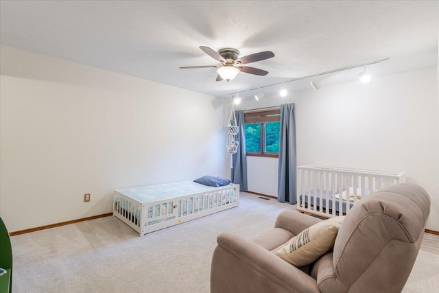 141 Manor Cir, Bloomington, IL 61704 - carpeted bedroom with rail lighting and a ceiling fan
