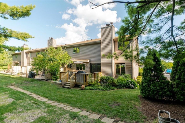 141 Manor Cir, Bloomington, IL 61704 - rear view of house with a chimney, a wooden deck, and a yard