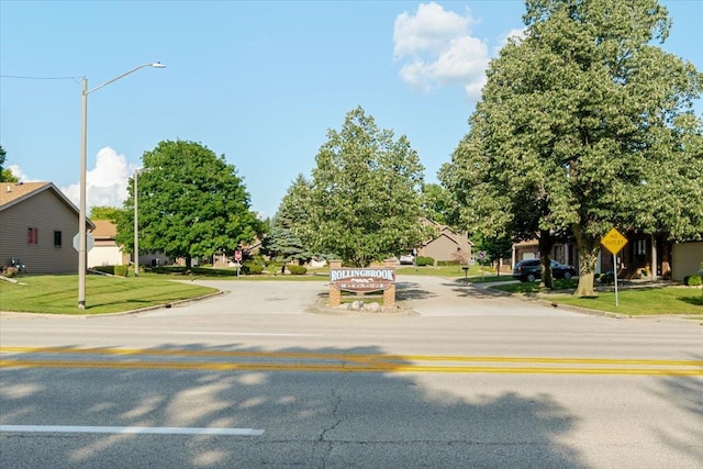141 Manor Cir, Bloomington, IL 61704 - view of asphalt road featuring street lighting, curbs, traffic signs, and a residential view