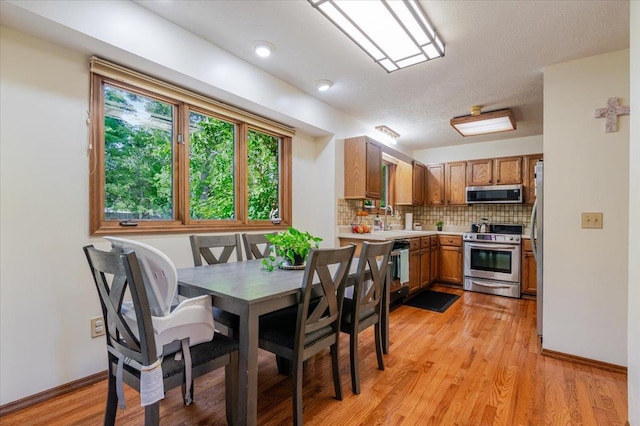 141 Manor Cir, Bloomington, IL 61704 - dining area with light wood-style flooring