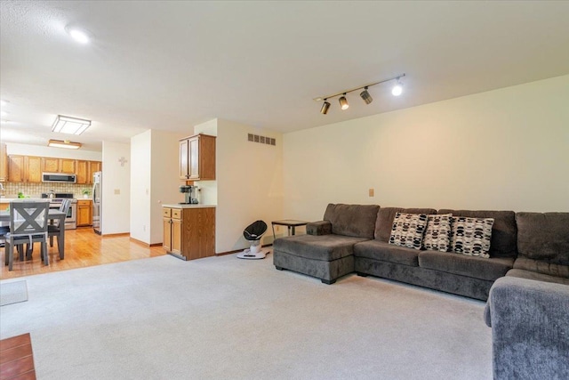 141 Manor Cir, Bloomington, IL 61704 - living room with light carpet and rail lighting