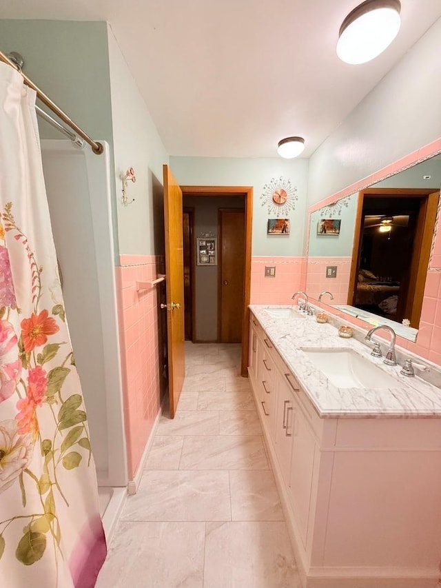 1217 S 7th Ave, Kankakee, IL 60901 - bathroom with tile walls, double vanity, a wainscoted wall, and a shower with shower curtain
