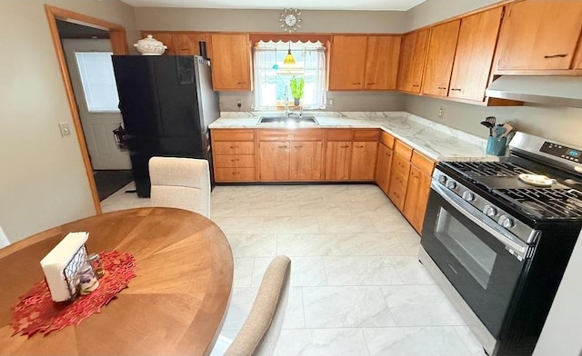 1217 S 7th Ave, Kankakee, IL 60901 - kitchen featuring stainless steel gas stove, extractor fan, freestanding refrigerator, and light countertops