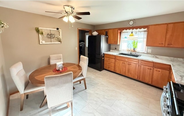 1217 S 7th Ave, Kankakee, IL 60901 - kitchen featuring freestanding refrigerator, stainless steel gas range oven, light countertops, and ceiling fan